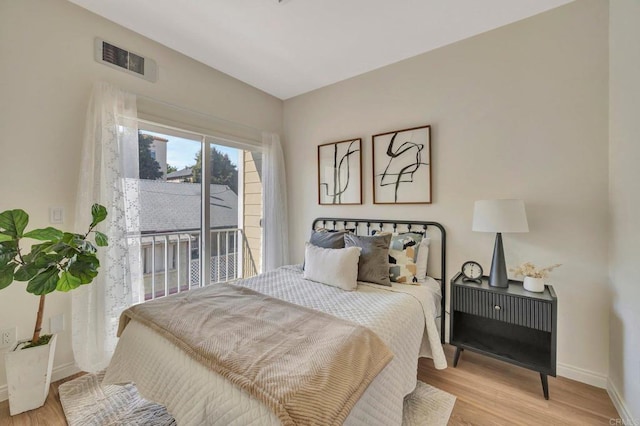 bedroom with access to outside and light hardwood / wood-style flooring