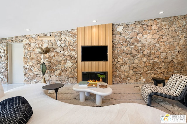 living room featuring vaulted ceiling and a fireplace