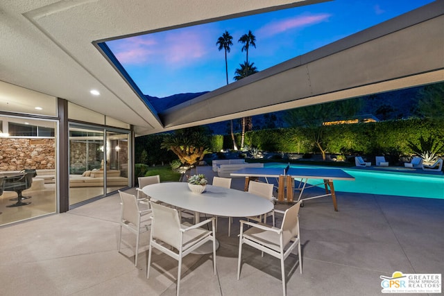 view of patio terrace at dusk