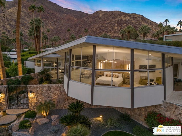 back house at dusk featuring a mountain view