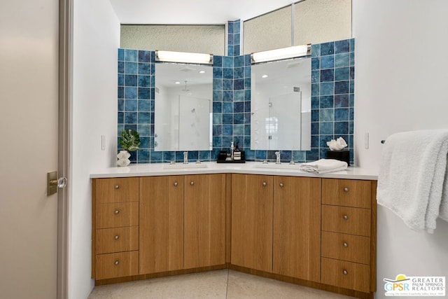 bathroom with decorative backsplash, walk in shower, vanity, and tile walls