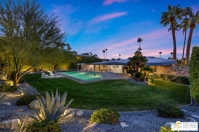 yard at dusk featuring a patio