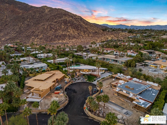 aerial view at dusk featuring a mountain view