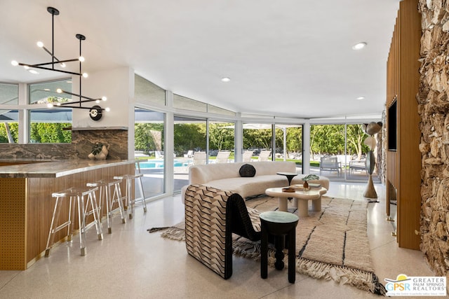 interior space featuring floor to ceiling windows and a chandelier