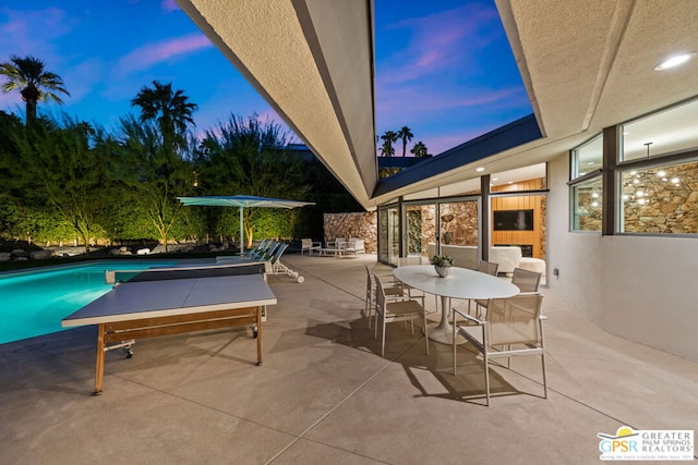 view of patio terrace at dusk