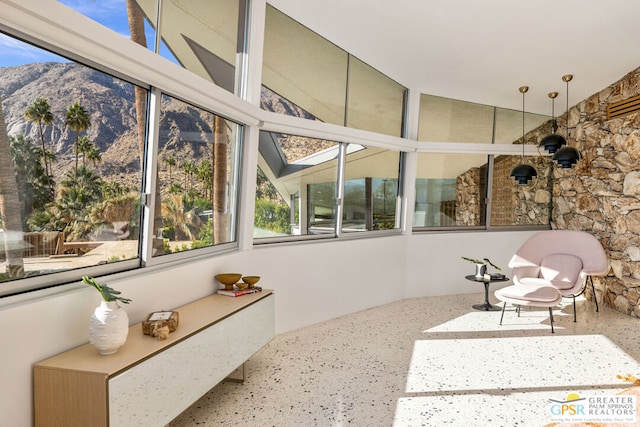 sunroom / solarium featuring a mountain view