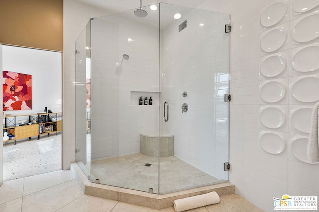 bathroom with walk in shower and tile patterned flooring