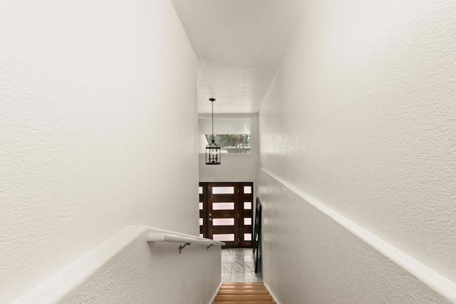 stairs featuring hardwood / wood-style floors