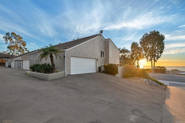 property exterior at dusk with a garage