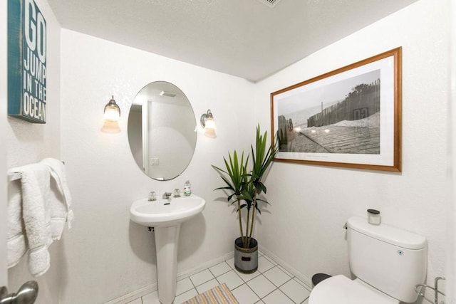 bathroom with tile patterned floors and toilet