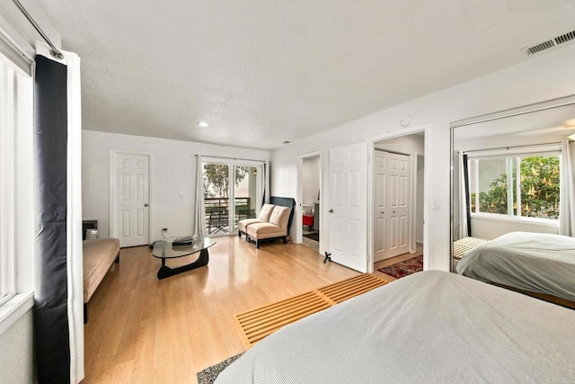 bedroom featuring hardwood / wood-style floors and access to outside