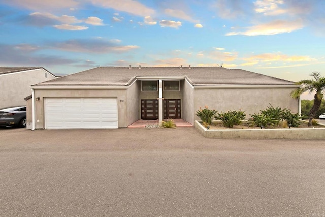 view of front of home with french doors and a garage