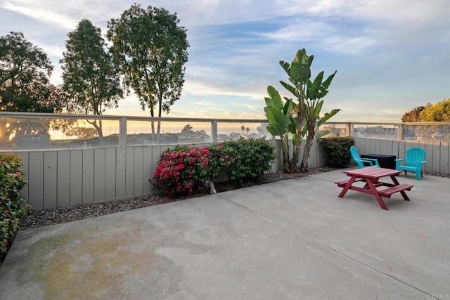 view of patio terrace at dusk