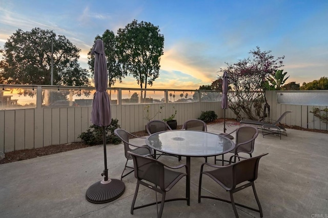 view of patio terrace at dusk