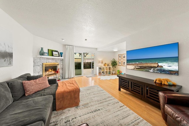 541 Camino Del Mar, Del Mar, CA 92014 - living room featuring a tile fireplace, wood finished floors, and a textured ceiling