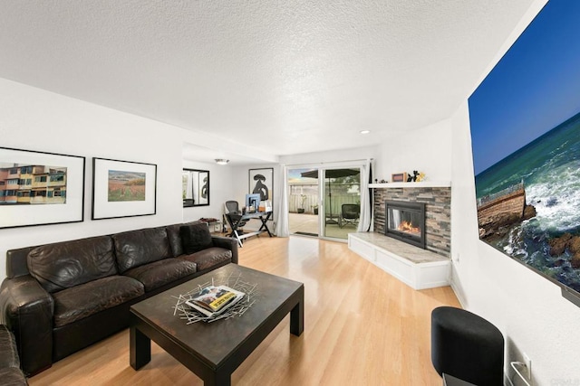 541 Camino Del Mar, Del Mar, CA 92014 - living area featuring a textured ceiling, light wood-type flooring, and a fireplace