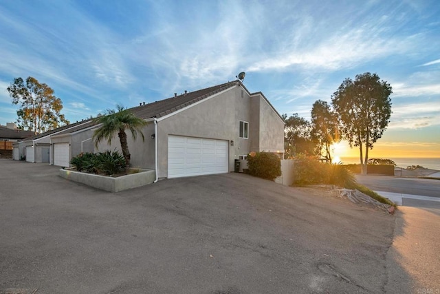 541 Camino Del Mar, Del Mar, CA 92014 - view of side of home featuring driveway, stucco siding, and an attached garage