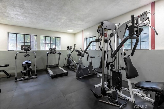 gym featuring a textured ceiling