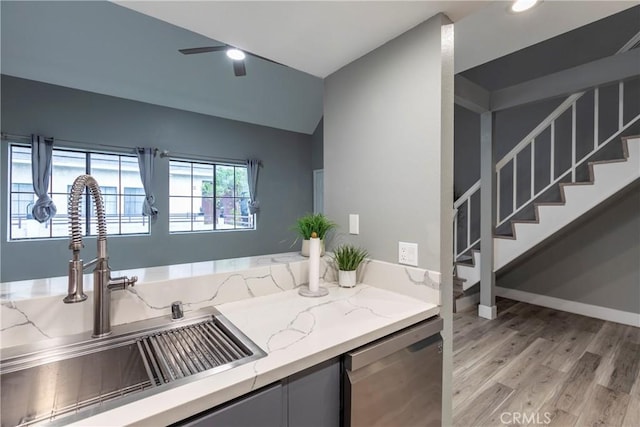 kitchen featuring lofted ceiling, sink, ceiling fan, dishwasher, and light wood-type flooring