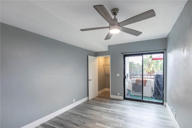 spare room featuring ceiling fan and light wood-type flooring