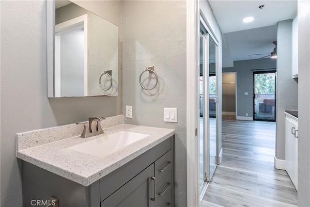 bathroom with vanity, hardwood / wood-style floors, and ceiling fan