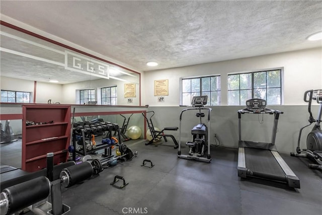 exercise room with a textured ceiling