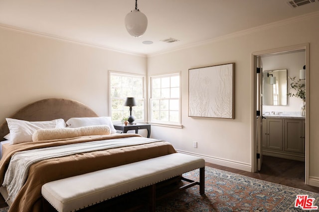 bedroom with ensuite bathroom, dark hardwood / wood-style flooring, and ornamental molding