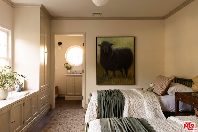 bedroom with ensuite bathroom, dark hardwood / wood-style flooring, and crown molding