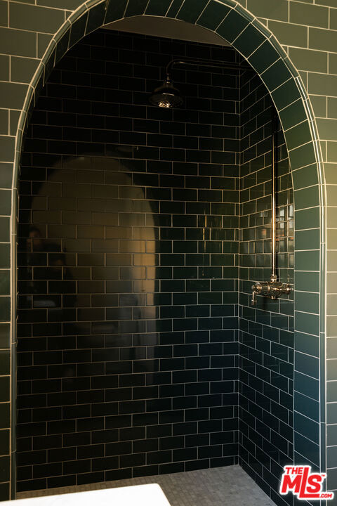 bathroom with tiled shower