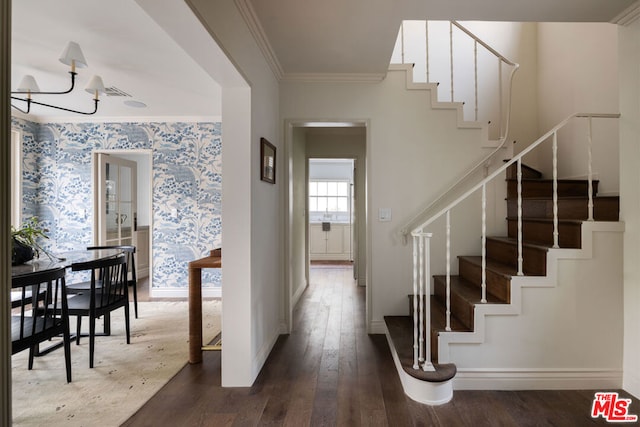 interior space featuring crown molding, a chandelier, and hardwood / wood-style floors