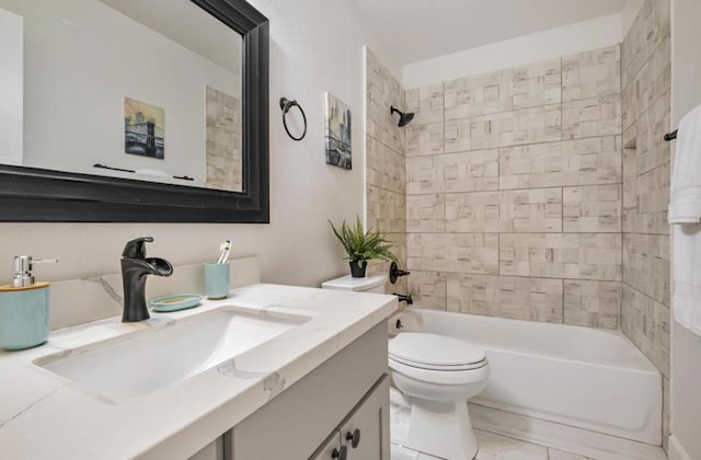 full bathroom with tiled shower / bath, vanity, and toilet