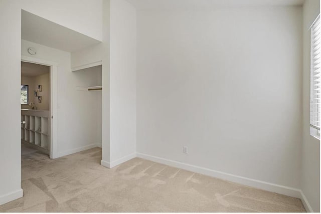 spare room featuring a healthy amount of sunlight and light carpet