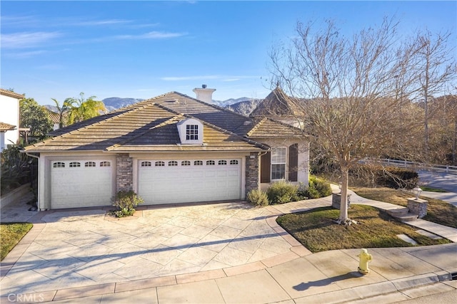 view of front of home with a garage and a mountain view