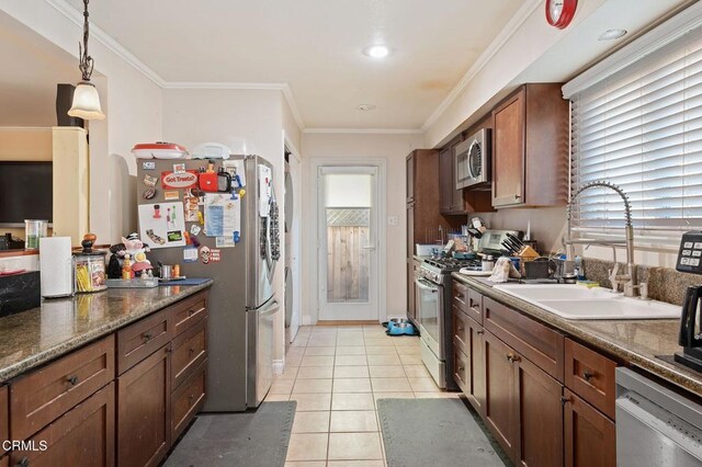 kitchen featuring light tile patterned floors, stainless steel appliances, decorative light fixtures, ornamental molding, and sink