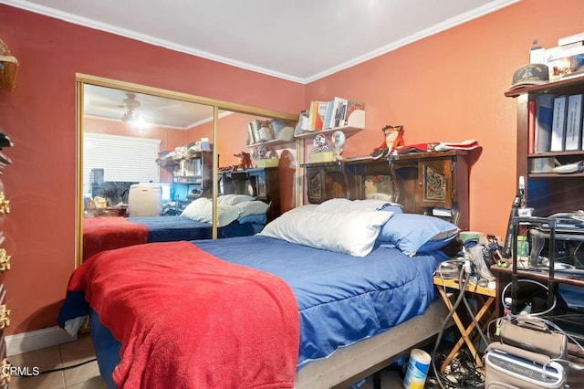 tiled bedroom featuring a closet and crown molding