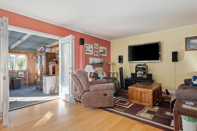 living room with hardwood / wood-style flooring and crown molding