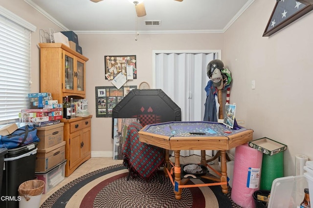 interior space with ceiling fan, light tile patterned floors, and crown molding