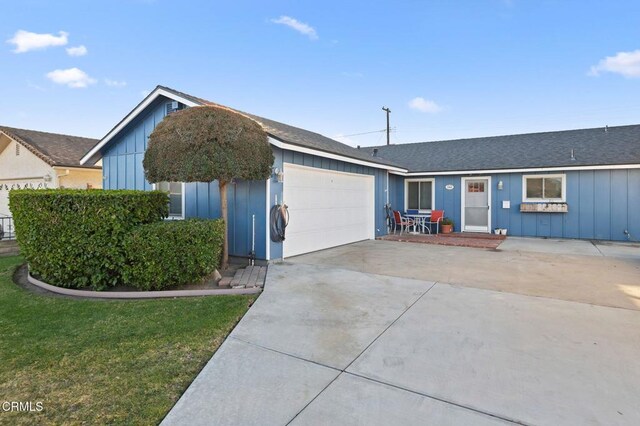 ranch-style home featuring a front yard and a garage