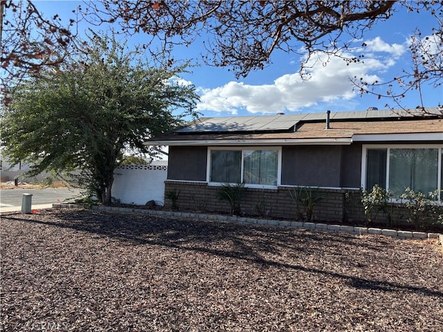 view of property exterior featuring solar panels