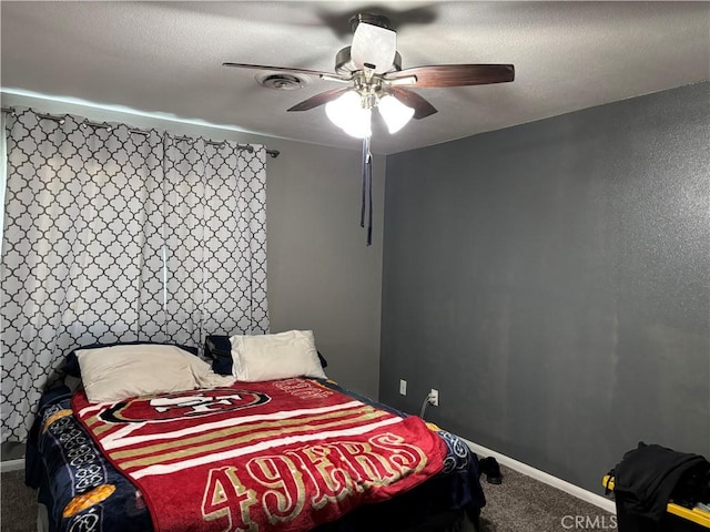 bedroom featuring a textured ceiling, ceiling fan, and carpet floors