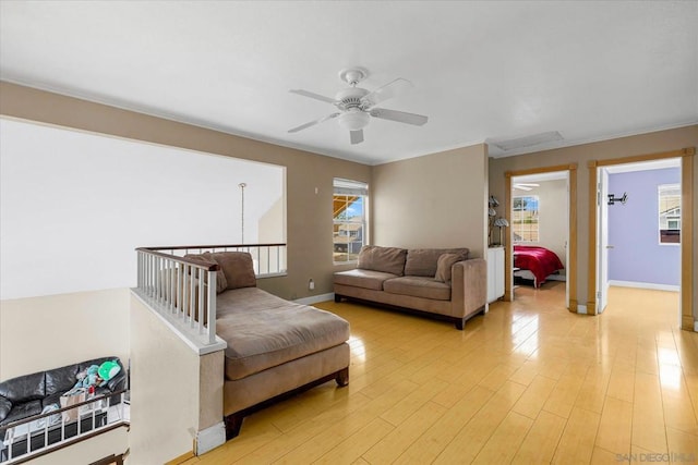 living room with ceiling fan and light wood-type flooring