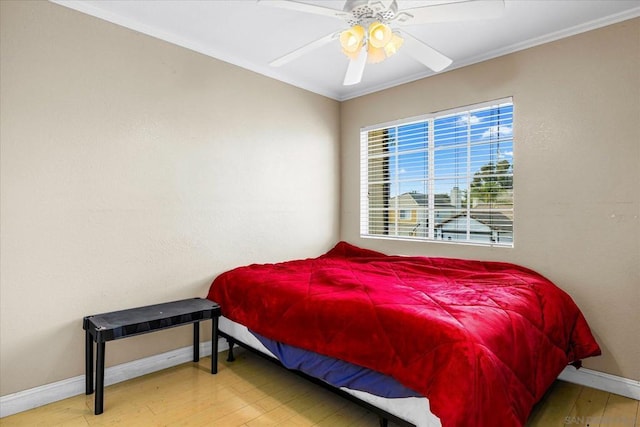 bedroom with ceiling fan, crown molding, and hardwood / wood-style flooring