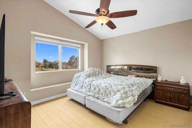 bedroom featuring ceiling fan, light hardwood / wood-style floors, and lofted ceiling