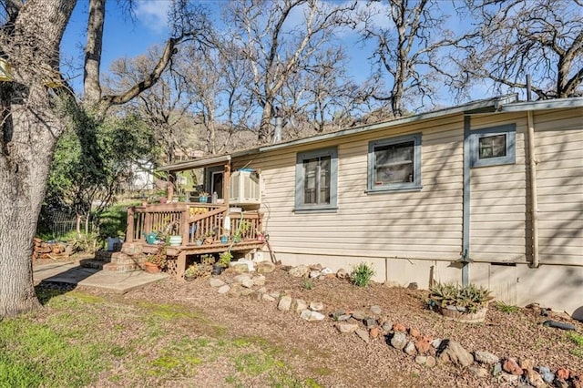 rear view of property with a wooden deck