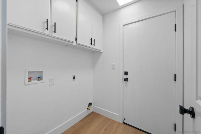 clothes washing area featuring washer hookup, cabinets, light hardwood / wood-style flooring, and electric dryer hookup