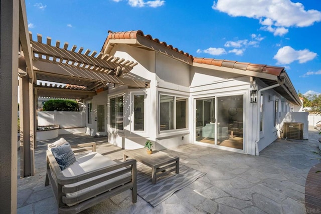 rear view of house featuring a pergola and a patio