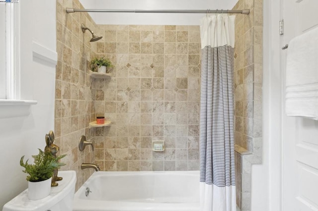 bathroom featuring shower / tub combo with curtain and toilet