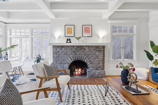 living room featuring beamed ceiling, coffered ceiling, and a fireplace