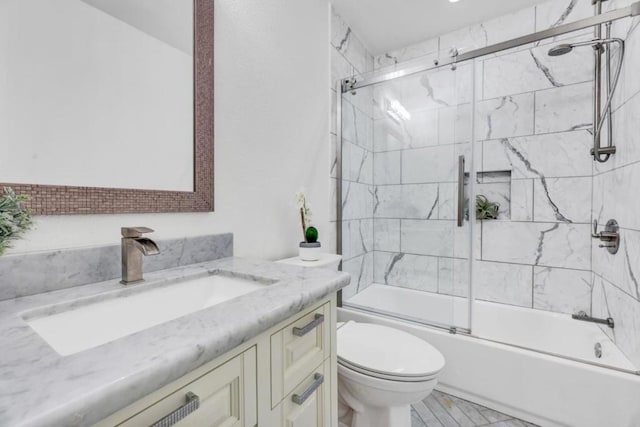 full bathroom featuring toilet, vanity, and combined bath / shower with glass door