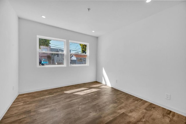 spare room with dark hardwood / wood-style floors